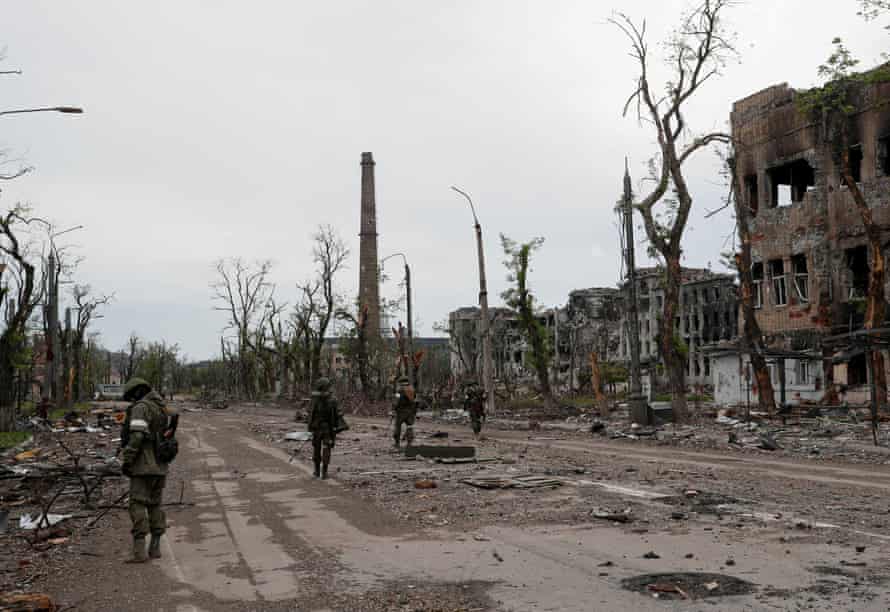 Russian service members seen on the the territory of Azovstal steel plant in Mariupol after Ukrainian defenders surrendered last month.