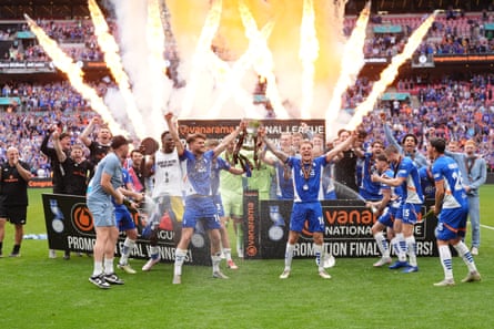 Oldham players celebrate with the trophy after their National League playoff victory