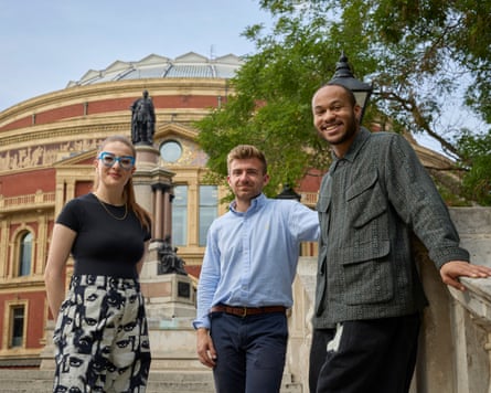The trio stand outside the Albert Hall, with Goldscheider and Kanneh-Mason leaning against a wall and Gillam holding her hands behind her back