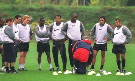 Arsène Wenger talks to his players during a training session in the 2001-02 season