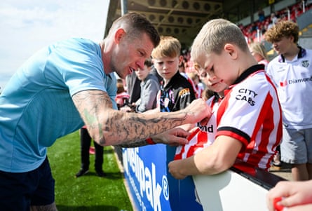 James McClean signs a fanâÂÂs shirt during a Derry City open training session