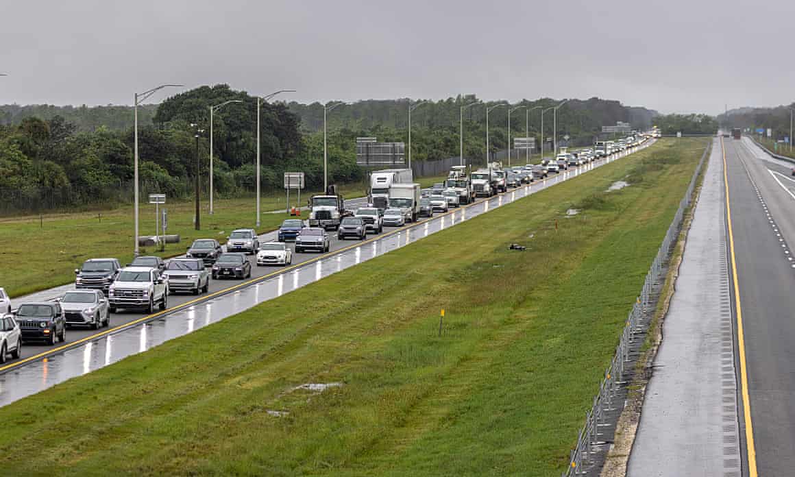 Bumper-to-bumper traffic is photographed against a gray, stormy sky on Interstate 75 in Naples, Florida.