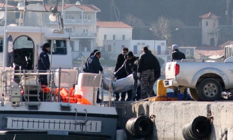 A coastguard vessel brings the bodies of some of the refugees to the port of Vathi