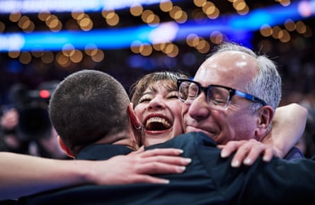 Alysa Liu reacts with her coaches, Phillip DiGuglielmo and Massimo Scali, after winning the world title on Friday night in Boston.
