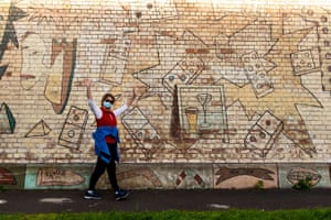 A woman poses in from of a mural in Port Melbourne.