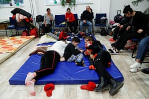 People from Ukraine rest at a refugee shelter in a culture house, after Russia launched a massive military operation against Ukraine, in Zahony, Hungary