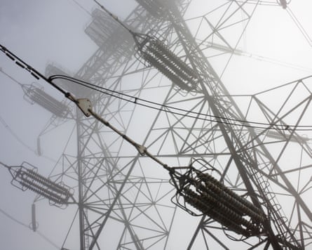 An electricity pylon cloaked in mist.
