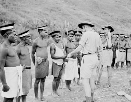 A patrol officer paying members of the Royal Papua New Guinea constabulary for their services in 1948.