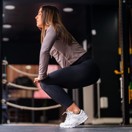 Woman performing a bodyweight squat with her heels raised