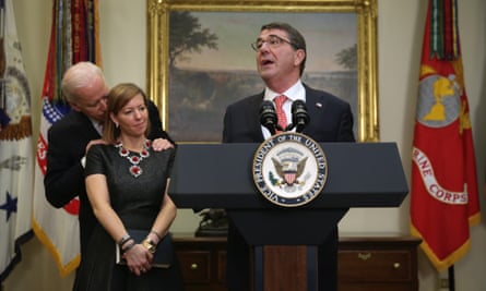 Joe Biden puts his hands on Stephanie Carter’s shoulders as her husband, Ashton Carter, is being sworn in as secretary of defense on 17 February 2015.
