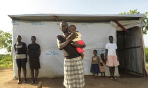 South Sudan refugee Gloria Keoji, holding her three-month-old son at Imvepi refugee settlement, flanked by her new family there, from left to right Betty Tomalu, Margaret Tomalu, Keoji s daughter, Sharon and Zubeida Flores