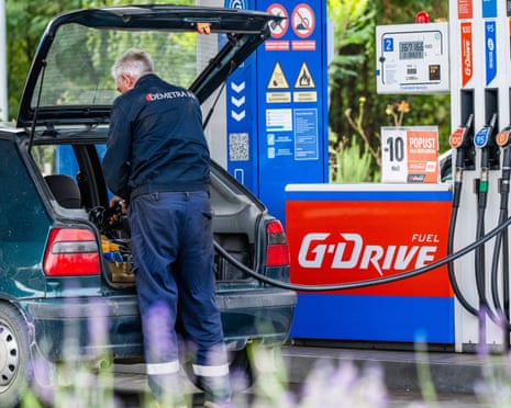 A man fills canisters at a Gazprom petrol station