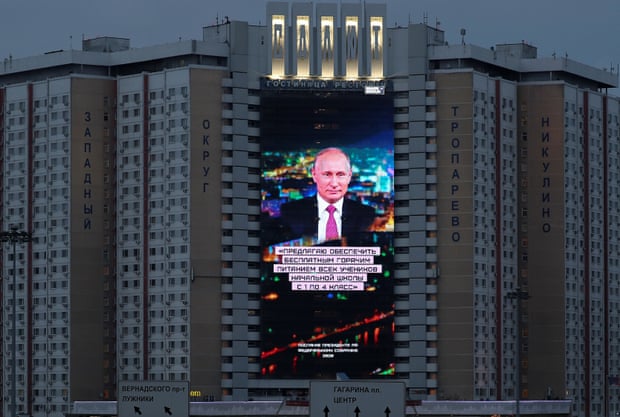 An electronic screen installed on the facade of a hotel depicts Putin during his annual address to the Federal Assembly in Moscow on Wednesday.