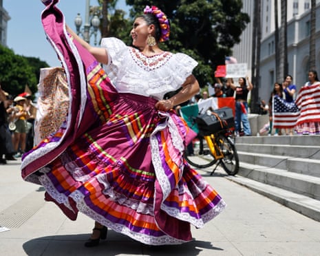 Dancers perform at a protest by mariachi and folklorico dancers outside City Hall.
