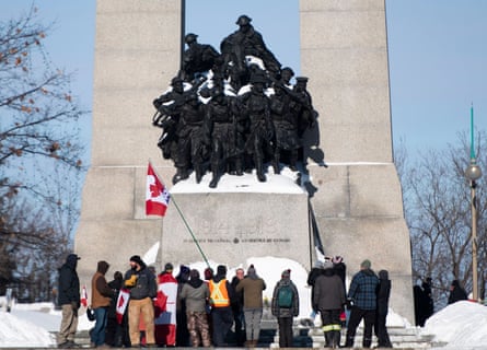 People surround the Tomb of the Unknown Soldier at the National War Memorial during a protest against Covid restrictions in Ottawa.