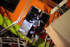 Emergency medical crews and firefighters search wreckage looking for survivors