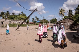 Women walk home from the mosque through streets still devastated by insurgent attacks over a year ago