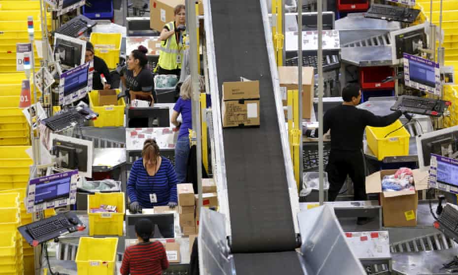 Workers prepare orders for customers at the Amazon fulfillment center in Tracy, California.