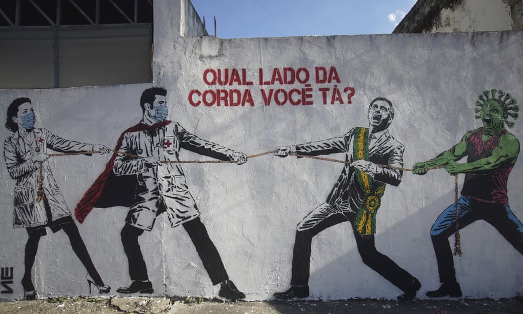 “Which side of the rope are you on?” Street art in Sao Paulo depicting health workers in a tug of war with Brazilian president Jair Bolsanaro and the coronavirus.
