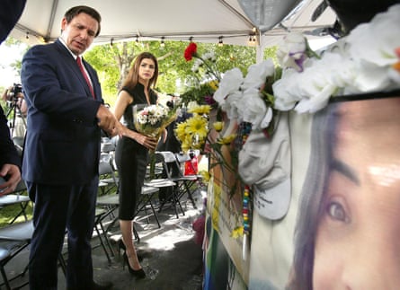 Ron DeSantis and his wife, Casey, carry flowers to the site of the Pulse nightclub in Orlando on the three-year anniversary of the shooting.