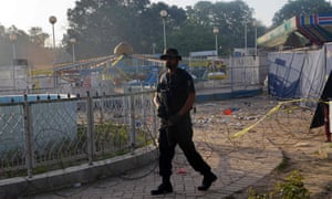 A Pakistani police commando stands guard at a Lahore following the suicide bombing that killed more than 70.