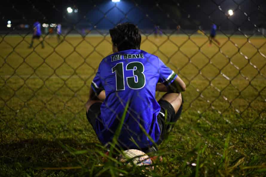 A member of QR The Brave FC watches his team.