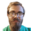 Man with very heavy moustache and beard, and glasses