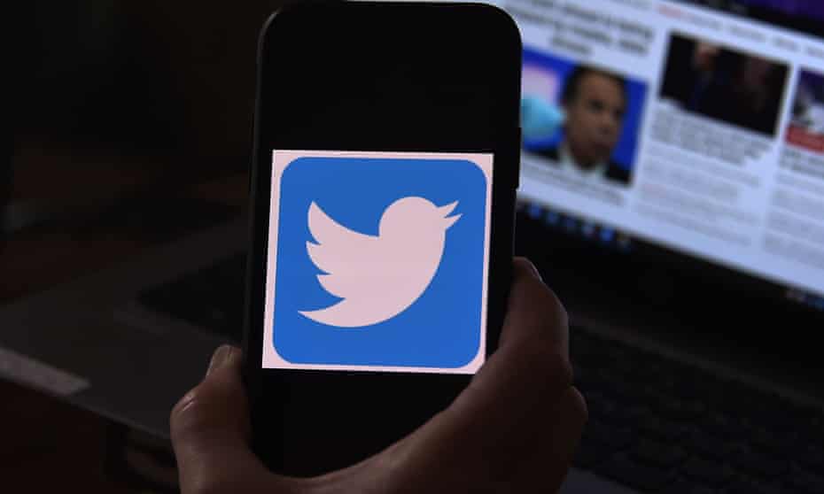 A Twitter logo on a mobile phone screen