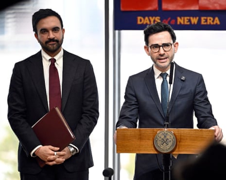 a man speak into a microphone next to another man