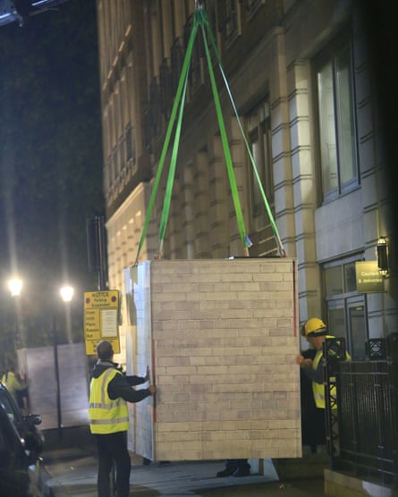 Greenpeace activists position one of the heavy containers outside BP headquarters