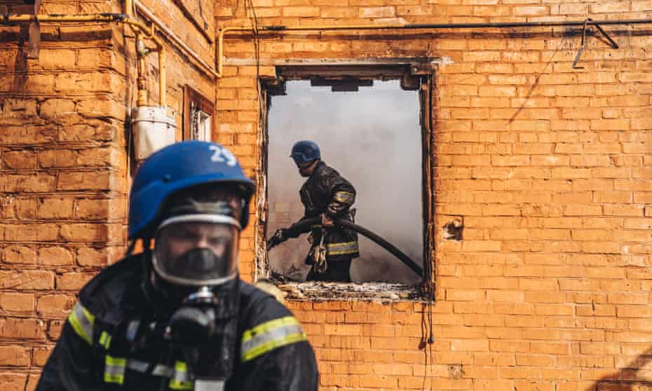 Firefighters extinguish a fire at the house hit by a Russian shell in Kyiv, Ukraine, on Wednesday.