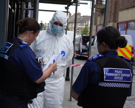 PCSOs and a forensics officer outside the building