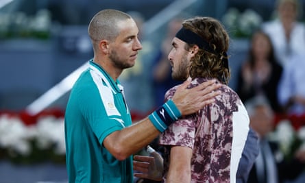 Jan-Lennard Struff consoles Stefanos Tsitsipas after his shock win over the Greek in Madrid.