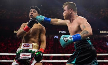 Canelo Álvarez lands a right hand on Jaime Munguía during their super middleweight title fight on Saturday night in Las Vegas.