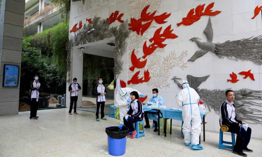 Students at Hubei’s Wuchang high school receive coronavirus tests.