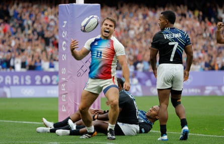 Antoine Dupont roars pinch delight aft scoring a effort for France successful nan golden badge lucifer against Fiji astatine nan 2024 Paris Olympics.