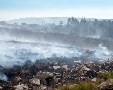 Smoke rises from smouldering land