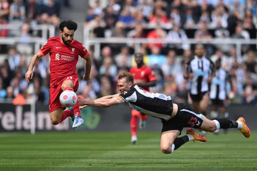 Newcastle’s Dan Burn tackles Mohamed Salah as Liverpool win 1-0.