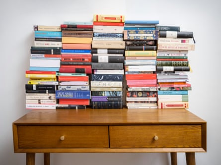 A side table piled high with books