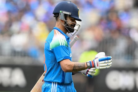 Virat Kohli walks off the field after his dismissal during the first one-day international cricket match between Australia and India in Perth