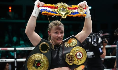 Lauren Price celebrates with the WBA and IBO belts after the victory over Jessica McCaskill in Cardiff.