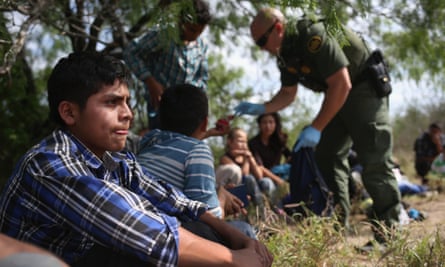 Border patrol agents detain people crossing into the US in Roma, Texas.