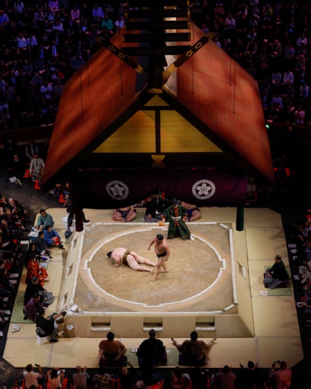 Osho is thrown to the floor by Hakuoho in their rematch after the first bout was ruled as a draw