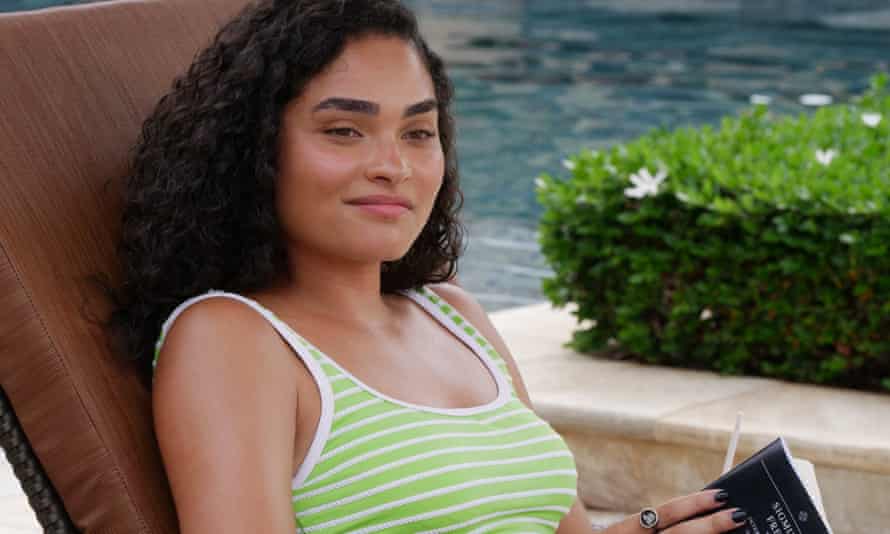 Brittany O'Grady as Paula, lounging by the pool