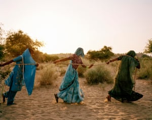 Women pull water from a well in the Thar desert
