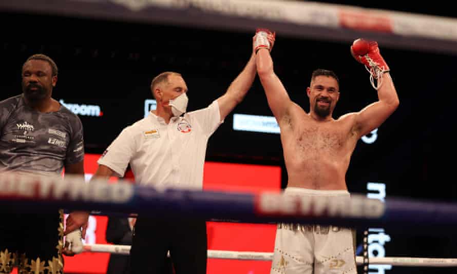 Derek Chisora looks disconsolate as Joseph Parker celebrates his victory in a split decision.