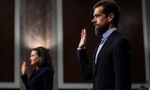 CEO of Twitter Jack Dorsey, right, and COO of Facebook Sheryl Sandberg are sworn-in before testifying at a Senate Intelligence Committee hearing on Wednesday.