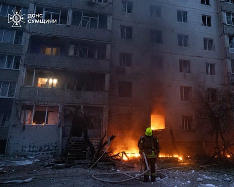 A firefighter works at the site of a residential building which was damaged during a Russian drone strike in Sumy, Ukraine.