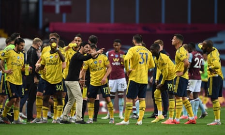 Mikel Arteta talks to his players in a drinks break during the match against Aston Villa.
