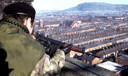 A British soldier takes aim at a suspect from an army observation post overlooking the New Lodge area of Belfast in February 1978.